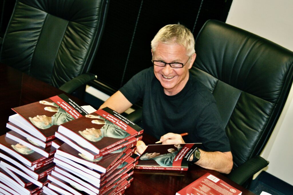 Dr. David Nunan signing copies of the Anaheim University Press textbook Teaching English to Young Learners